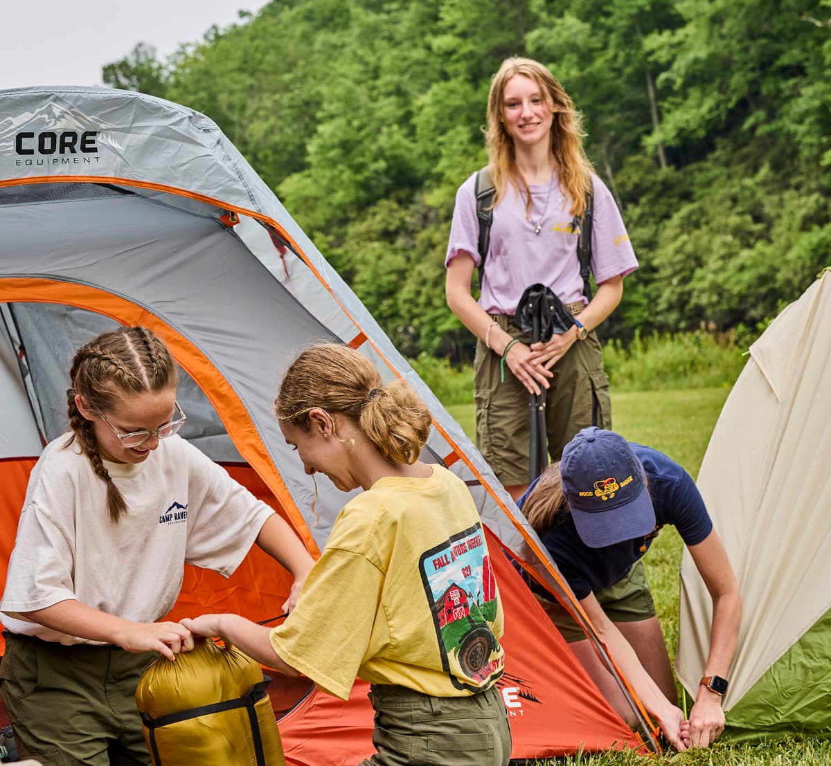 Female Scouts setting up tents.